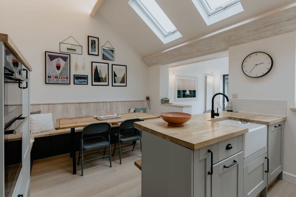 open plan kitchen with belfast sink and wood counter tops