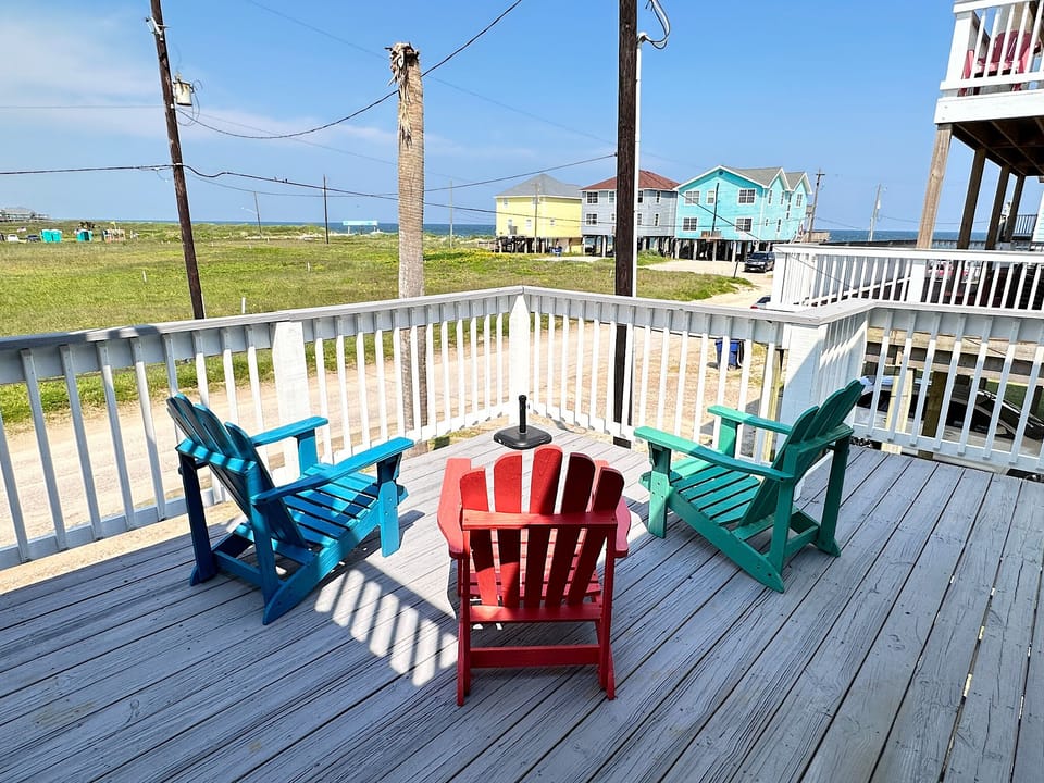 Adirondack chairs facing the ocean