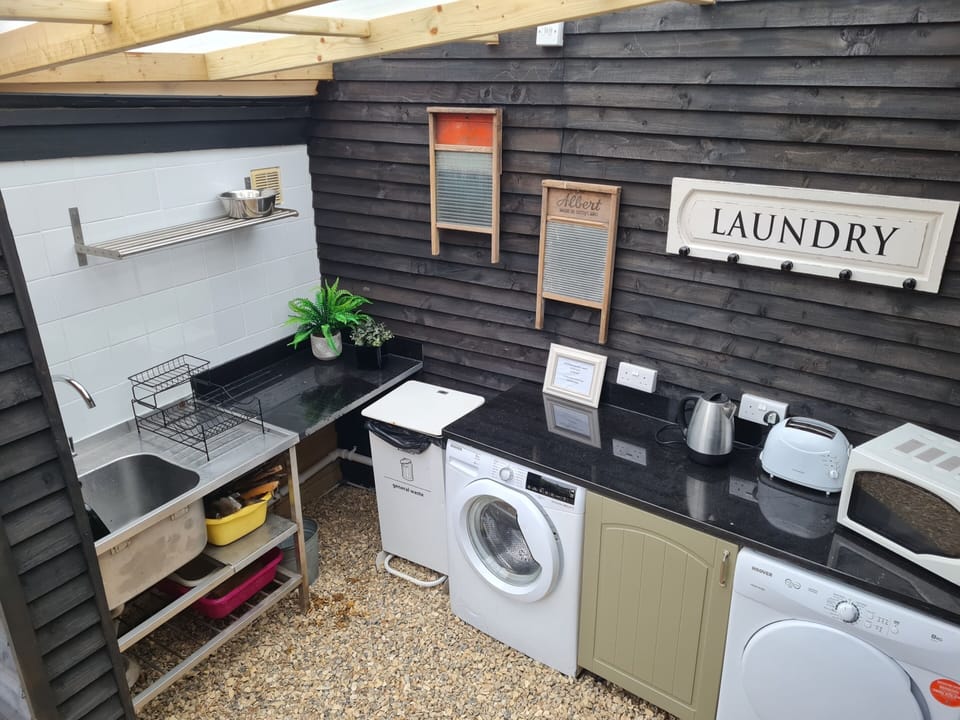 Communial washing up area with microwave, toaster and kettle. Washing machine and tumble dryer also available at a cost.