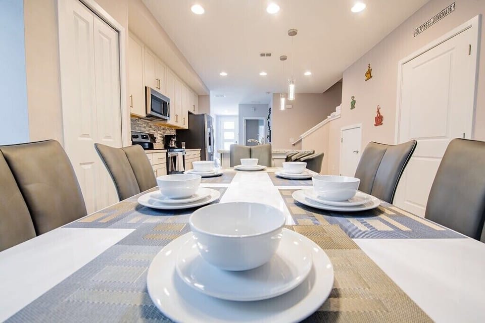 This is our stunning  dining room, where beauty and warmth collide in a symphony of elegance. This vibrant space exudes an inviting charm, perfect for gathering with loved ones over delicious meals. With its spacious layout and comfortable seating, it's the ideal setting for creating unforgettable vacation memories with family and friends.