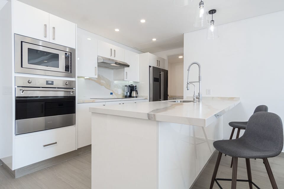 the kitchen with bar stool seating