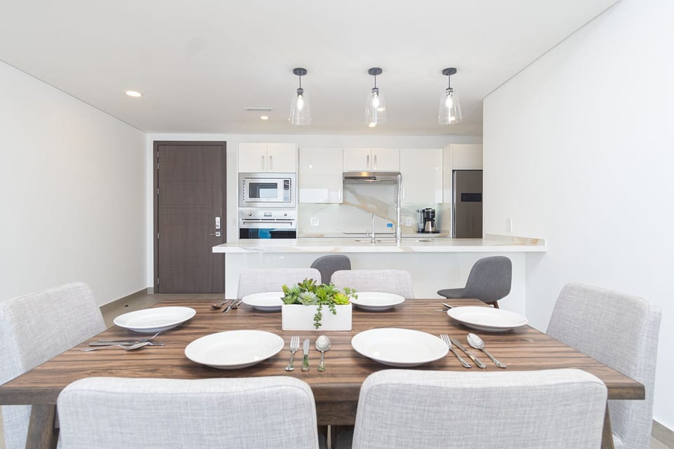 Dining table with kitchen behind