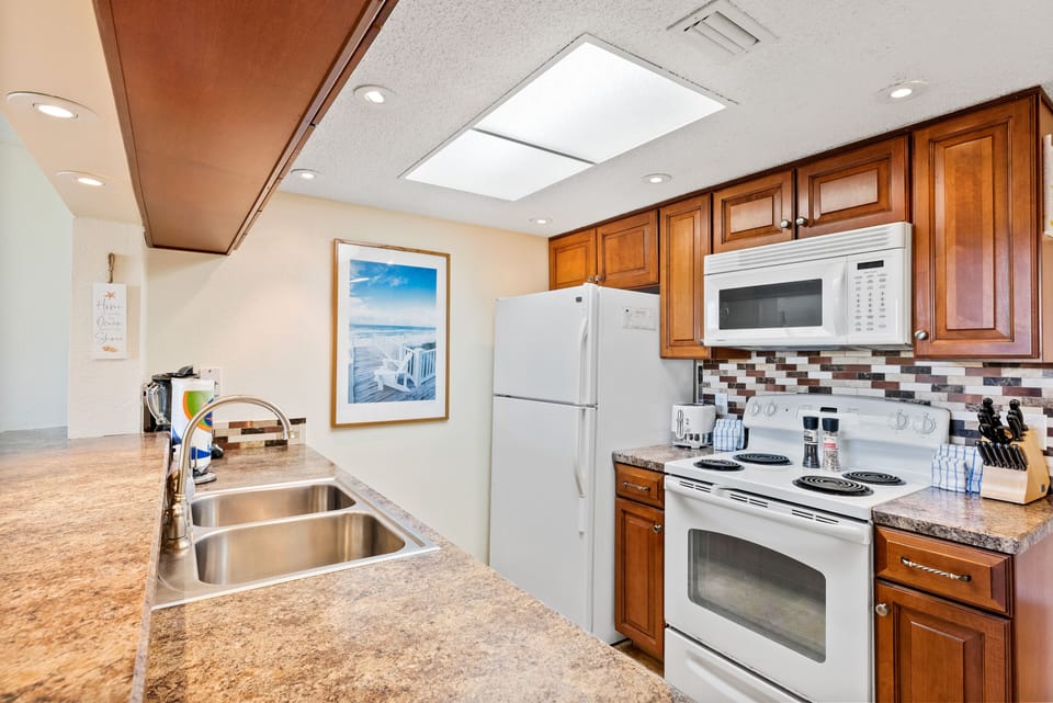 Fully equipped kitchen with wooden cabinetry.