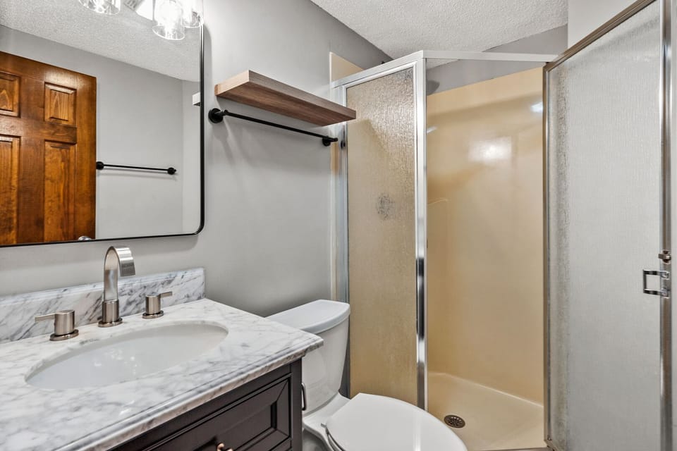 Shower, vanity and an open shelf in a bathroom at Sedgefield 403 in Cherry Grove, North Myrtle Beach