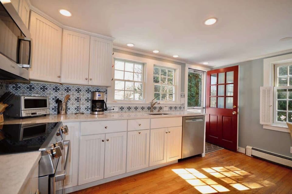 Newly renovated kitchen opens onto back deck and yard 