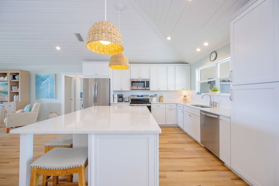 The kitchen welcomes you to gather around the island and savor morning coffee or family recipes together
