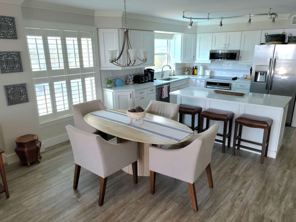 Comfortable and chic dining room with unique stone table beach cottage style.