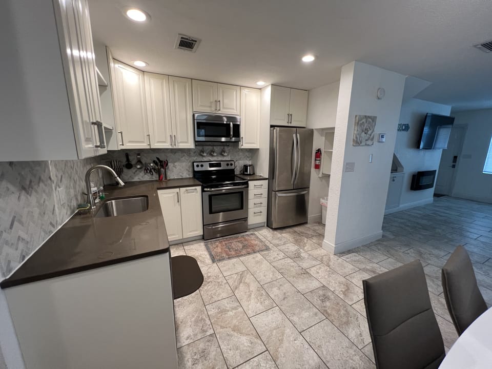 A modern kitchen with range/oven, microwave, dishwasher,  disposal, ...