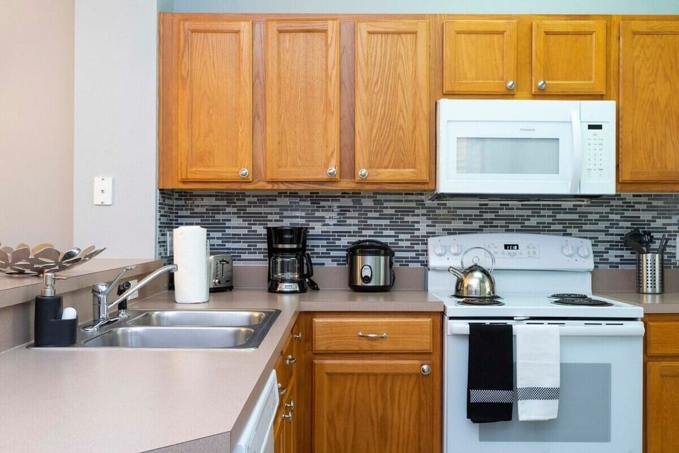The cozy kitchen is equipped with the essentials for preparing meals for your family  and enjoying a casual dining experience