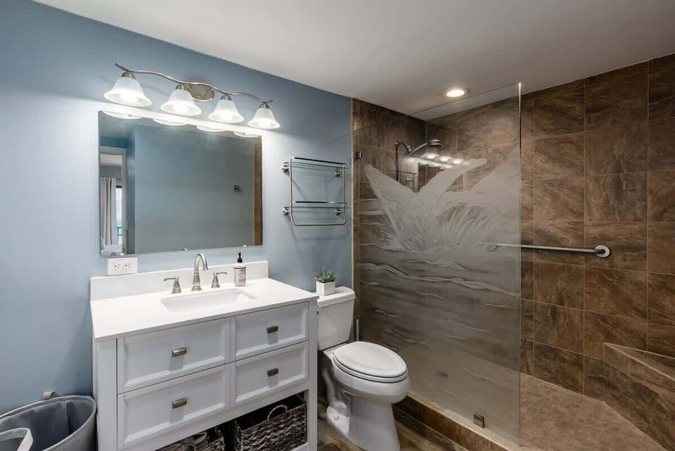 Modern bathroom with a fantastic walk-in shower. Rinse off after a day at the beach with ease!