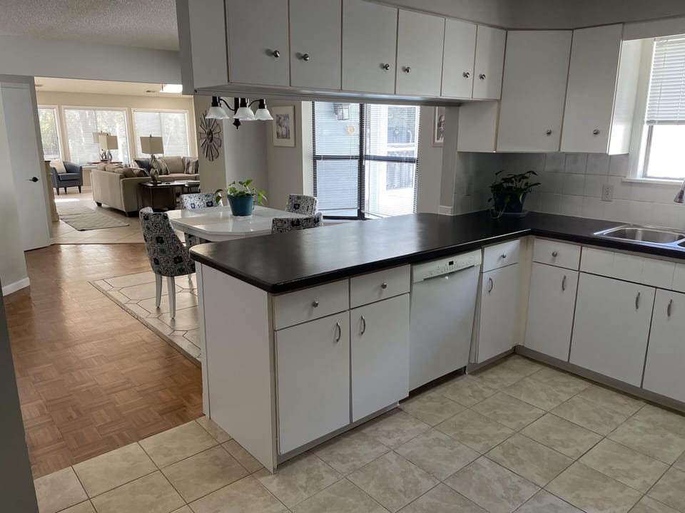Kitchen, island and view of living room.
