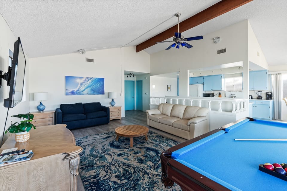 Open layout connecting living, dining, and entertainment spaces