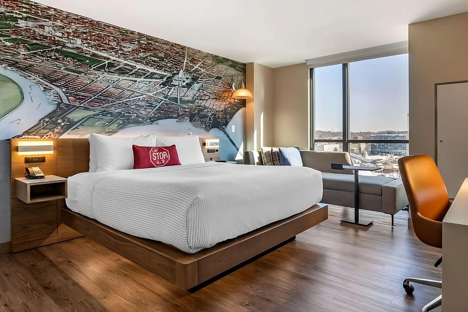 Unwind in a sunlit corner room with iconic mural backdrop.