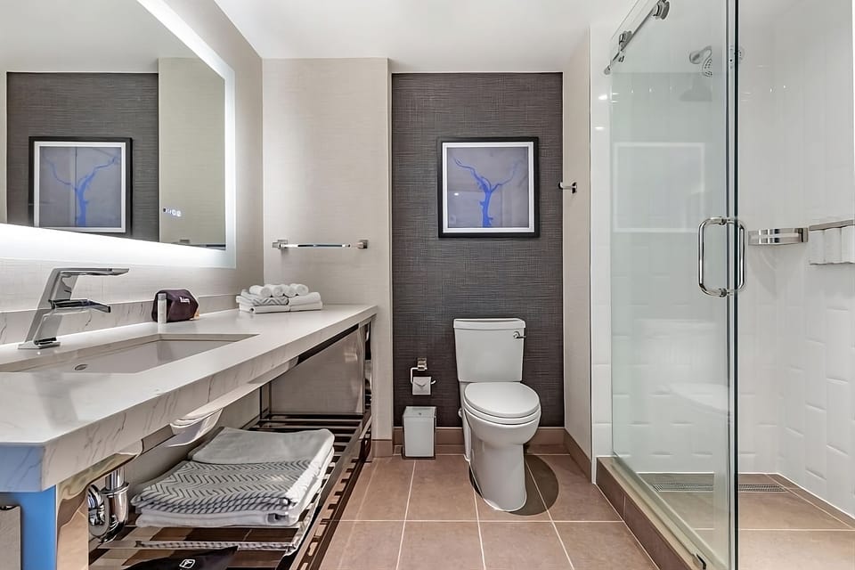Refresh in a sleek bathroom with bright vanity lighting.