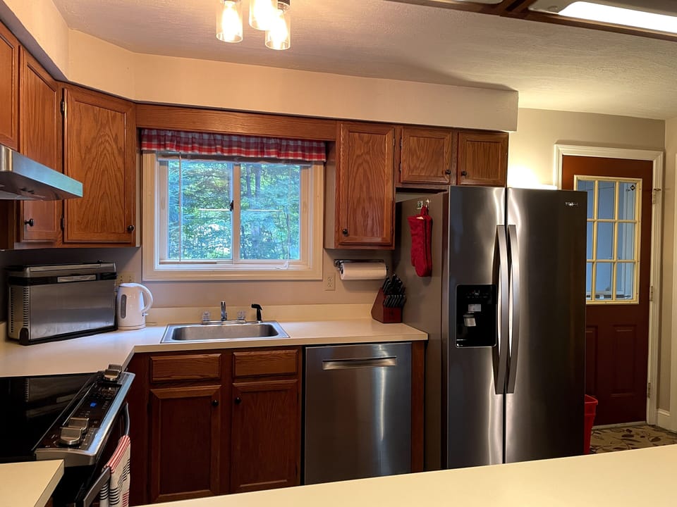 Kitchen stainless-steel appliances and is fully-equipped for cooking.