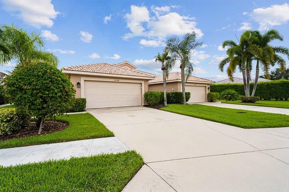 Front with 2 car driveway and garage