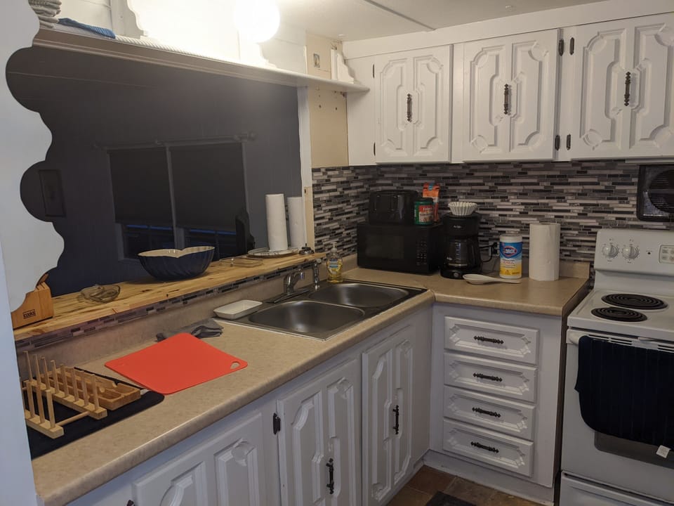 Kitchen with coffee maker, toast and microwave oven
