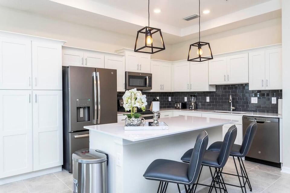 The fully equipped kitchen features modern appliances, sleek cabinetry, and all essential cookware and utensils, making it perfect for preparing meals with ease.