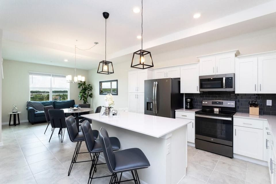 The fully equipped kitchen features modern appliances, sleek cabinetry, and all essential cookware and utensils, making it perfect for preparing meals with ease.