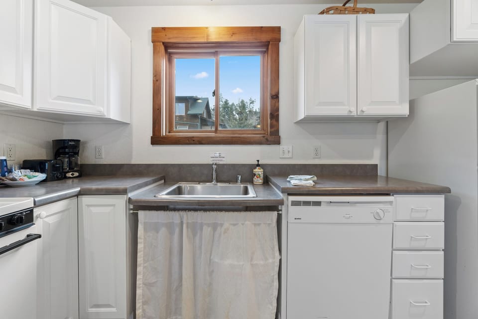 A fully equipped kitchen with a breakfast bar for casual dining or morning coffee.
