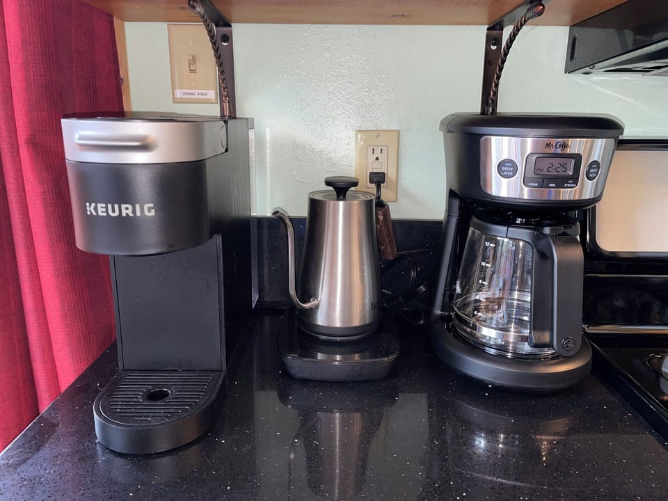 Coffee/Tea station. K-cups, teas, cream, sugar, mugs & travel cups are available