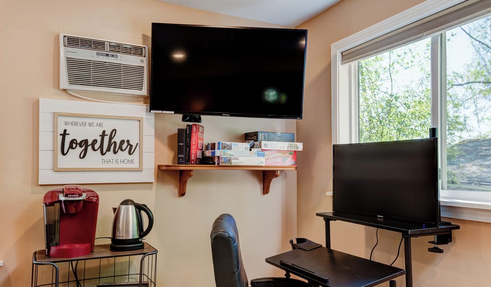 Chalet #9B desk with 30” gaming monitor to the right when you first walk in.