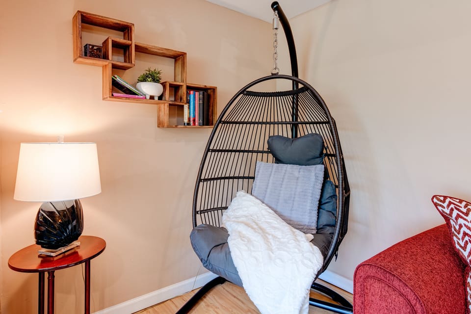 A very cozy corner of living room with a swing chair. 