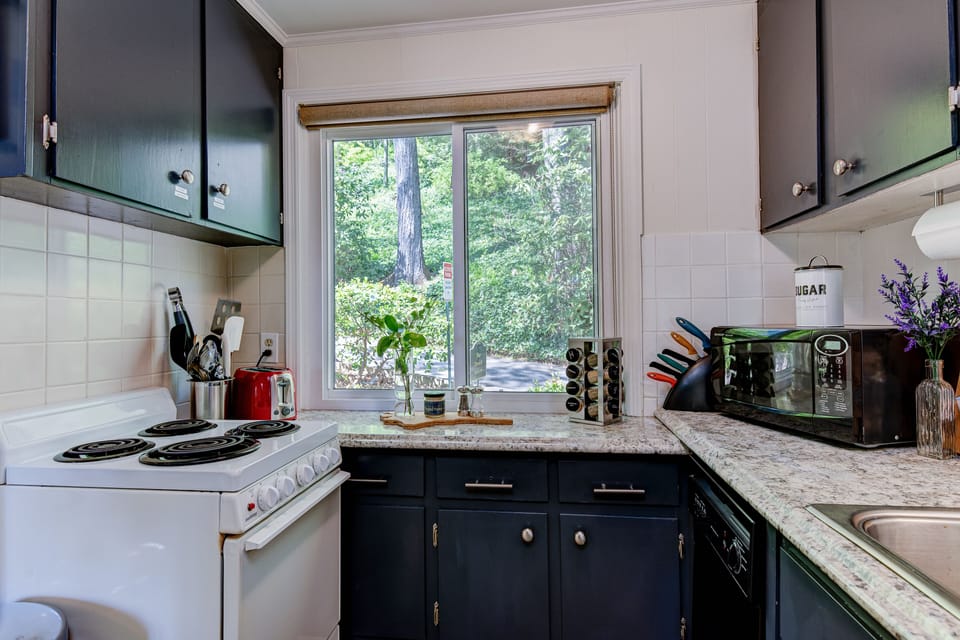 Chalet #9A kitchen with a big bright window and beautiful greenery.