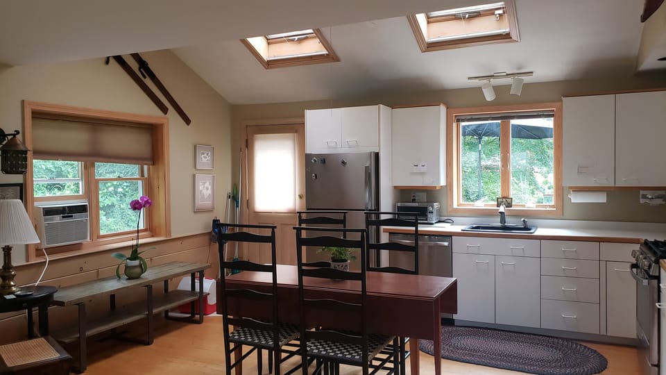 Rear Entry next to fridge to deck beyond kitchen