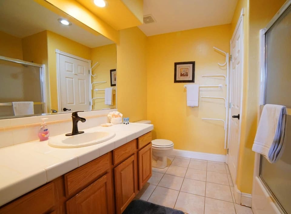 Bedroom #1's en suite bath has a vanity, a tub/shower, and plenty of storage space.