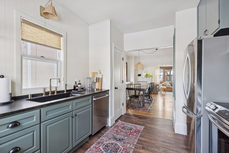 Open concept main living space with full kitchen, dining and living room.