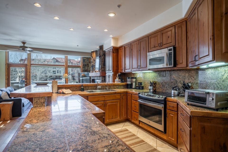 Kitchen offers modern appliances and counter-top seating.
