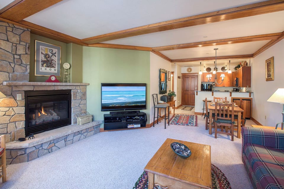 Cozy living room with a fireplace, comfortable seating and a TV to keep you entertained.