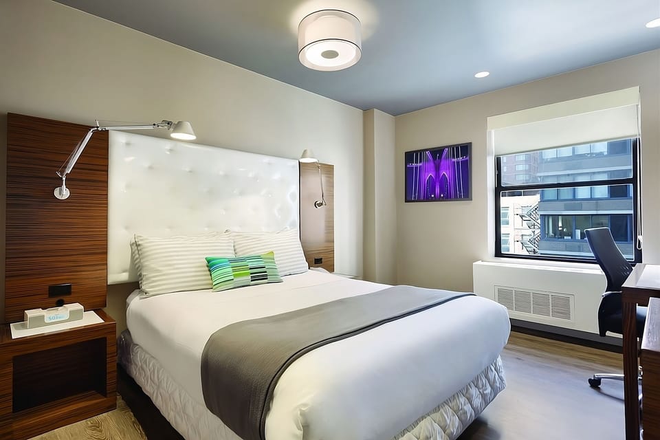 Recharge in a serene king room with dedicated workspace.