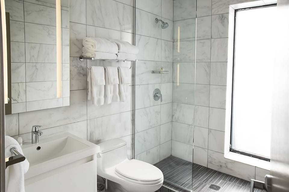 Refresh in a sparkling tiled shower with fresh, fluffy towels.
