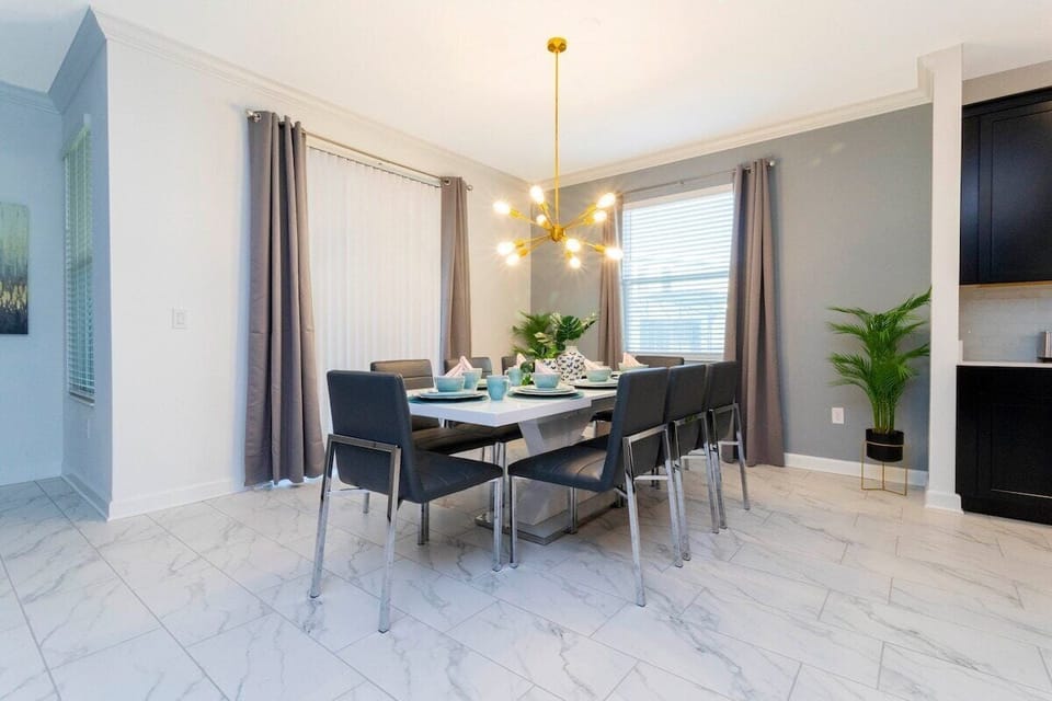 This space is an elegant and spacious dining room, perfect for a guest seeking a comfortable and luxurious experience. 