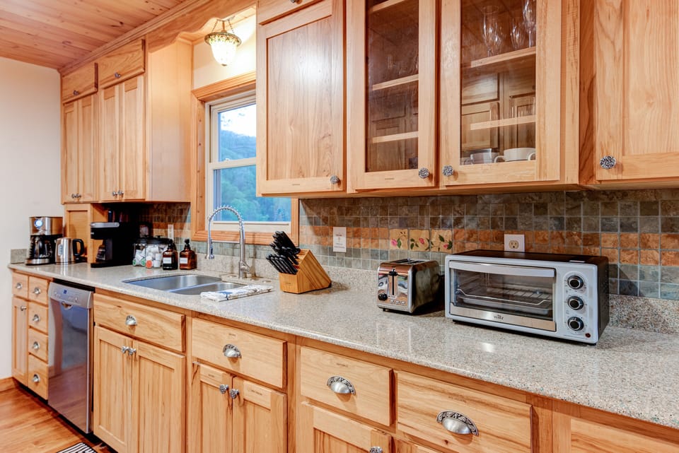 Kitchen with toaster, toaster oven, coffee, tea, wine glasses