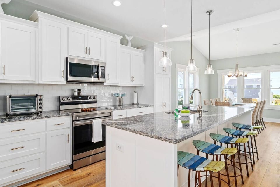 Fully-Equipped Kitchen with Ample Cookware and Utensils: A Spacious Island Perfect for morning waffles, pancakes from our waffle bar, and evenings of dining and entertaining!