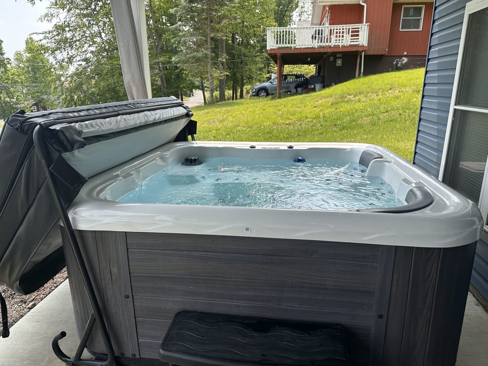Hot Tub on lower patio in front of home. 