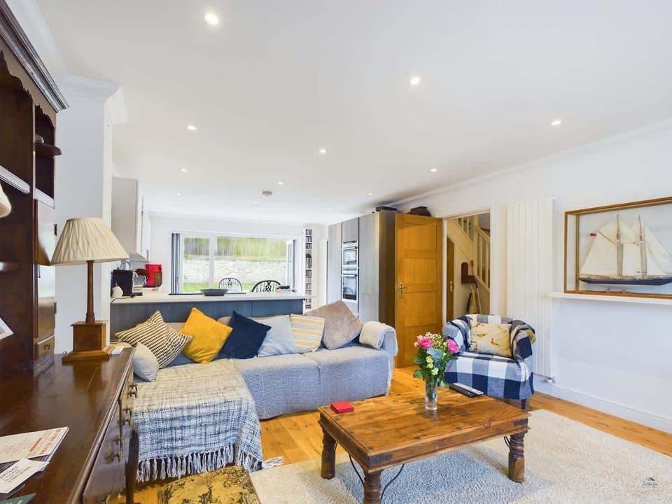 A second view of the spacious family lounge, highlighting the stylish coastal decor and natural light.