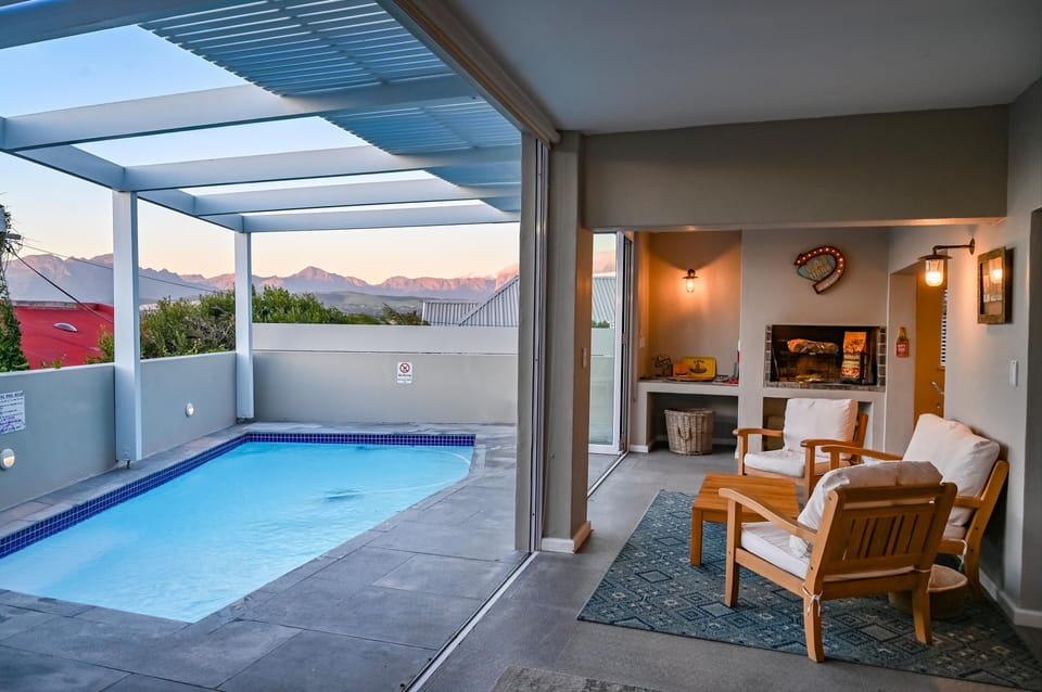 The pool and the living room with a braai.