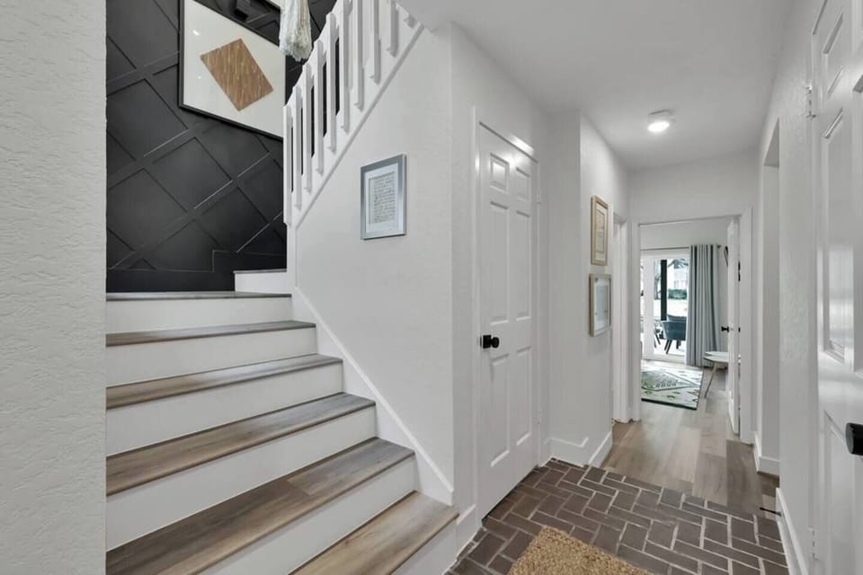 Upstairs to the main living space.  You will find a full kitchen, open living room and dining room, and the primary bedroom and bathroom.

There is also a 2 story deck over looking the water that you can access