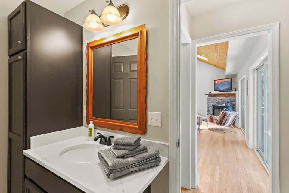 Illuminate your grooming ritual with a well-lit mirror, stylish sink, and clever storage solutions in our bath – where practicality meets elegance effortlessly.