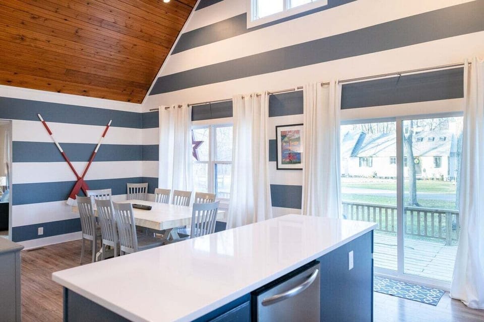 Large dining area with vaulted ceilings and spacious farmhouse table.