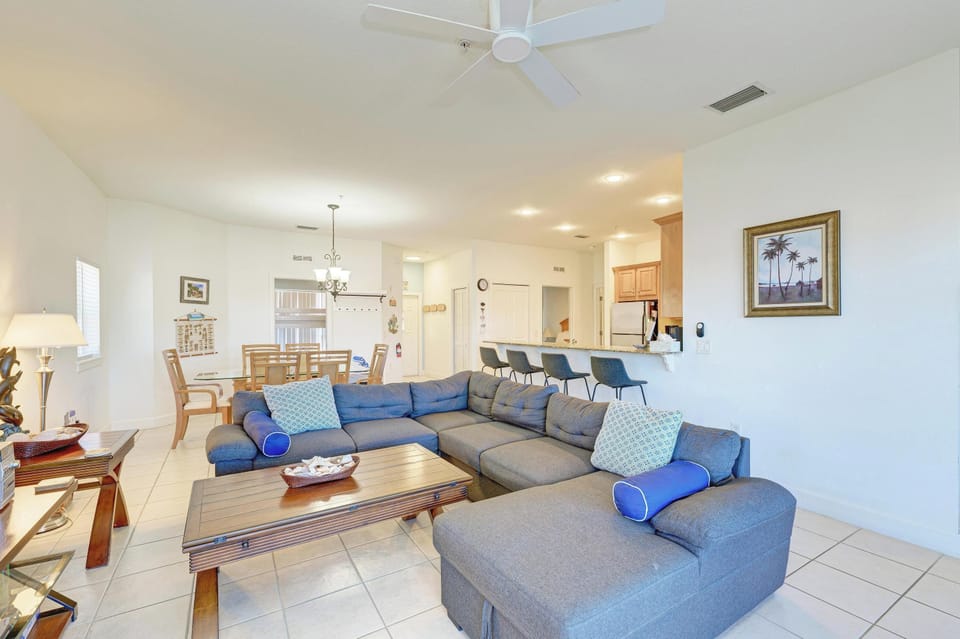 Relax in your spacious living room with plush sectional seating and soaring ceilings that create an airy, welcoming atmosphere.