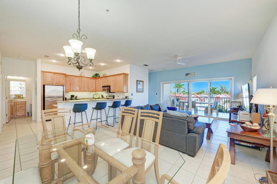 Your open-concept space flows seamlessly from kitchen to dining to living room, with tropical views from your private balcony.