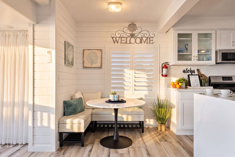 Cozy eat-in nook area in kitchen. Washer / dryer area to left.