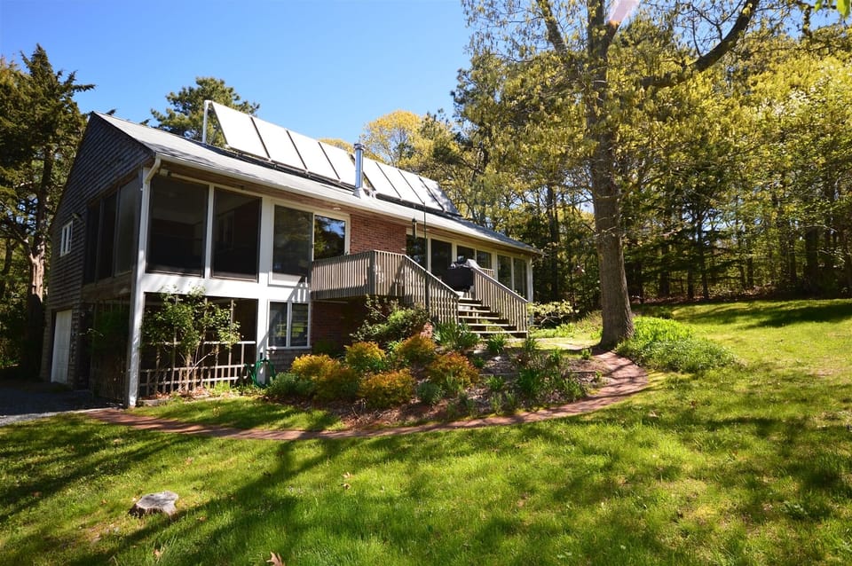 Back of house, passive solar panels and deck with grill