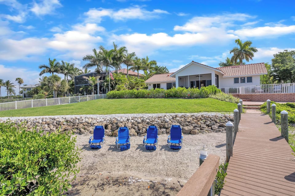 View from the pier at the house with the beach area in the foreground