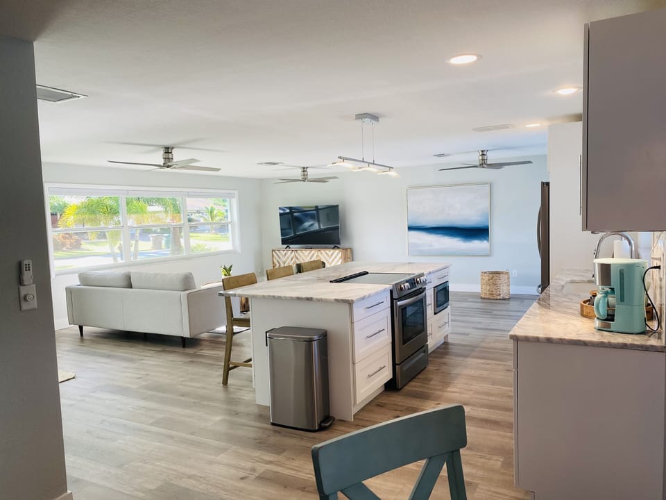 Newly renovated kitchen and living room with views of the pool and canal 